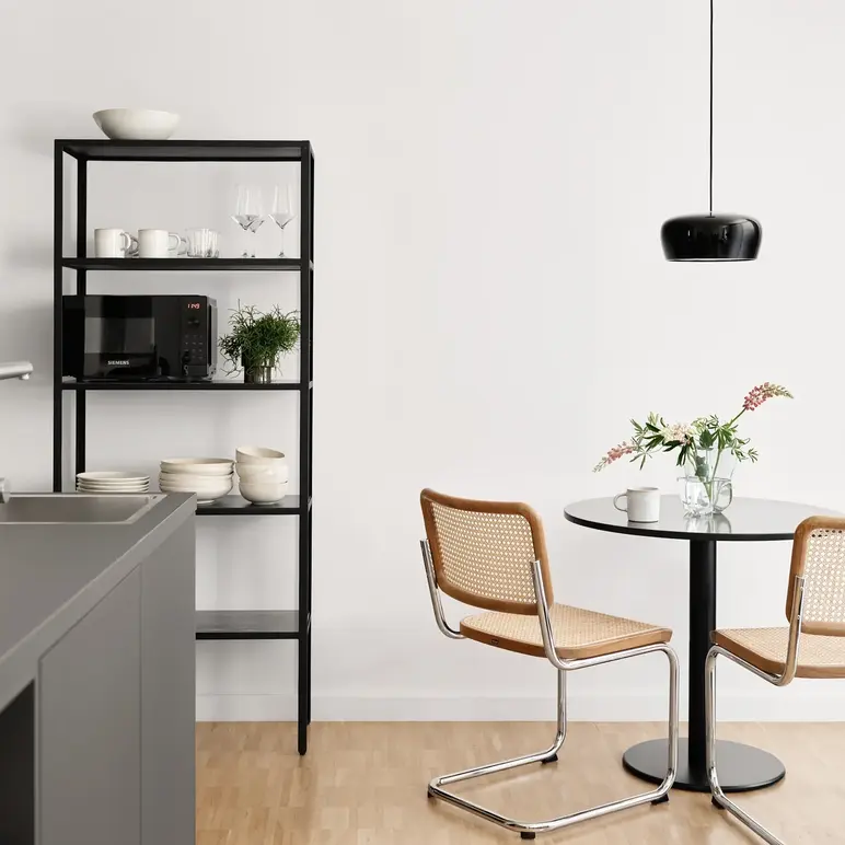 a kitchen with a table and chairs