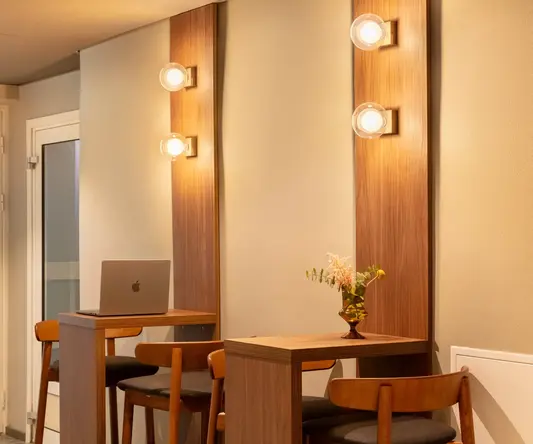 a room with a laptop and chairs