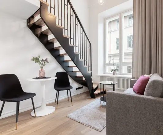 a room with a staircase and a couch