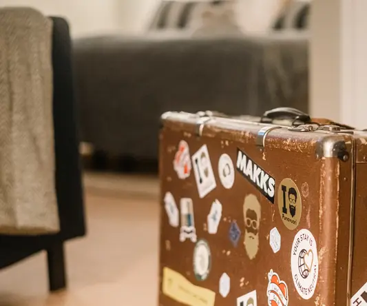 a suitcase with stickers on it