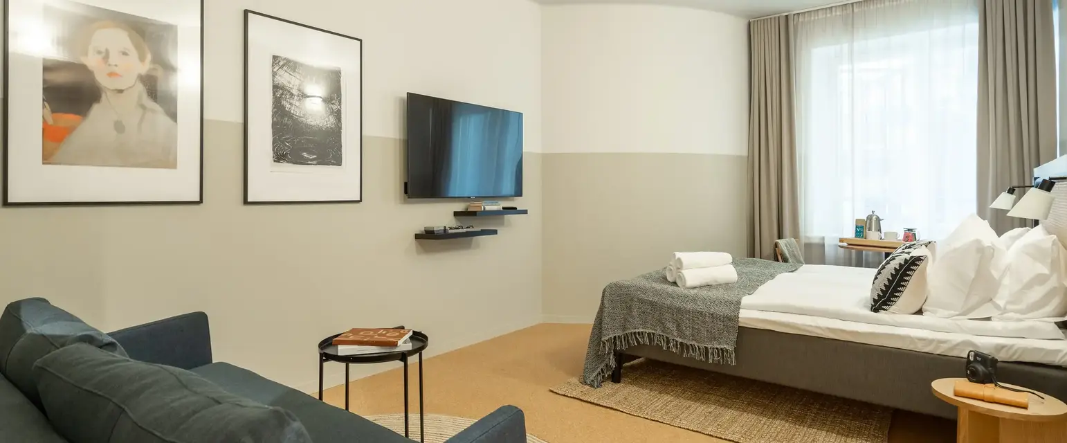 a room with a bed and a television