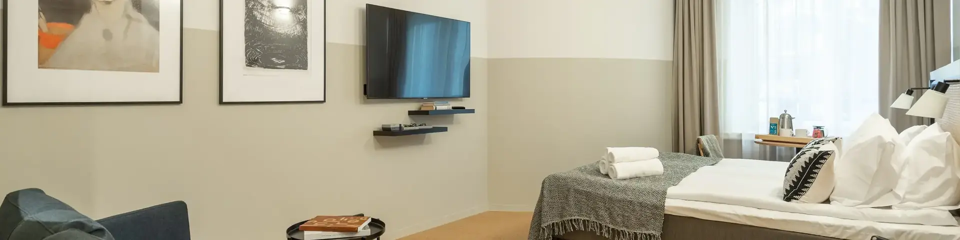 a room with a bed and a television