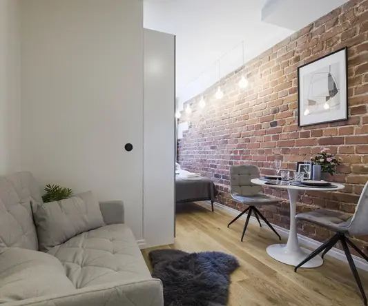 a room with a brick wall and a couch