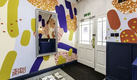 a room with a mirror and a door