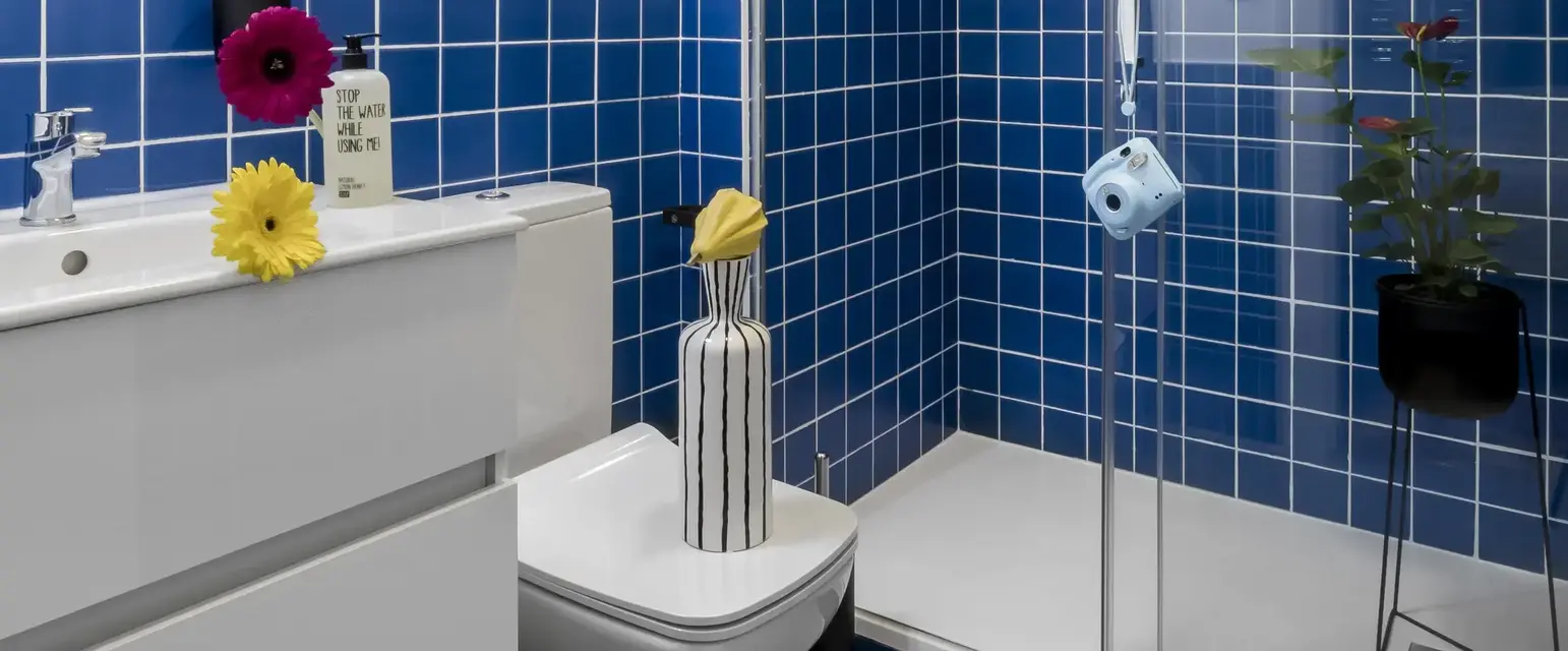 a bathroom with blue tiles