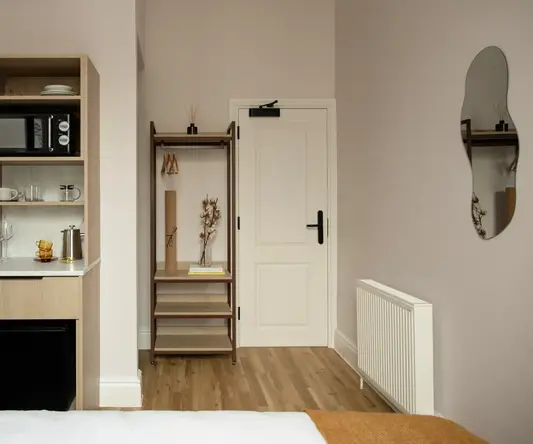 a room with a door and a shelf