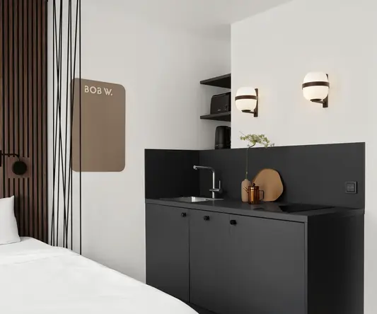 a room with a bed and a sink