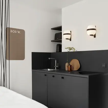 a room with a bed and a sink