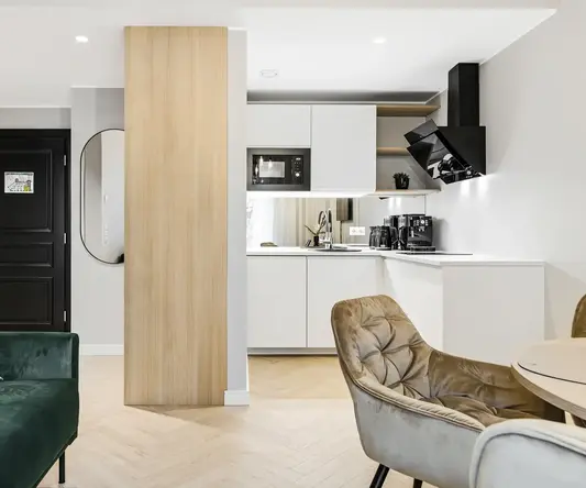 a living room with a couch and kitchen