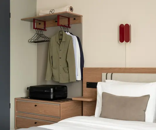 a room with a bed and a bed with a bed and a dresser