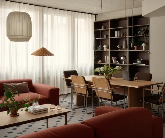 a living room with a table and chairs