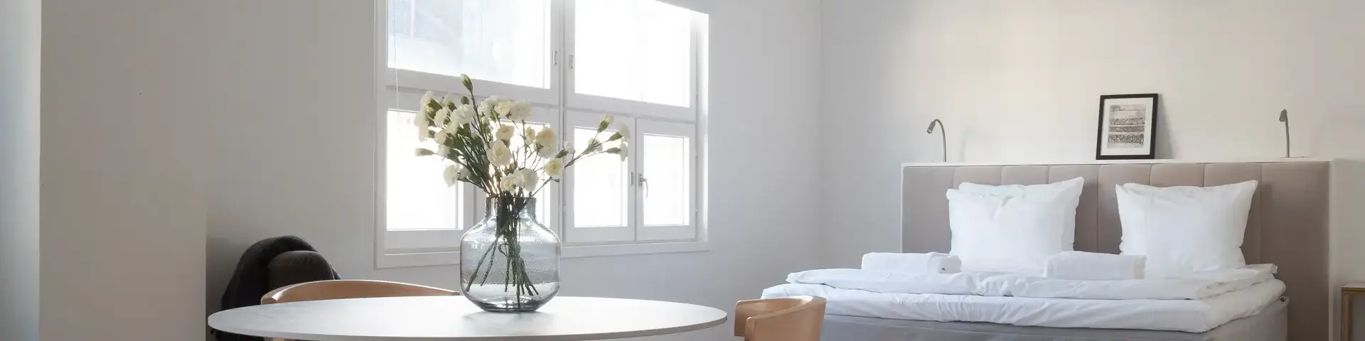 a room with a bed and a table and chairs