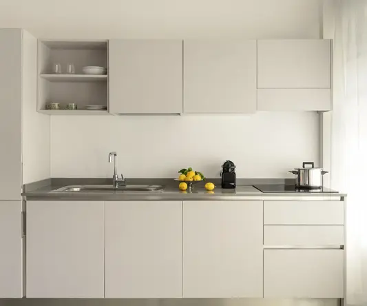 a kitchen with white cabinets and a sink