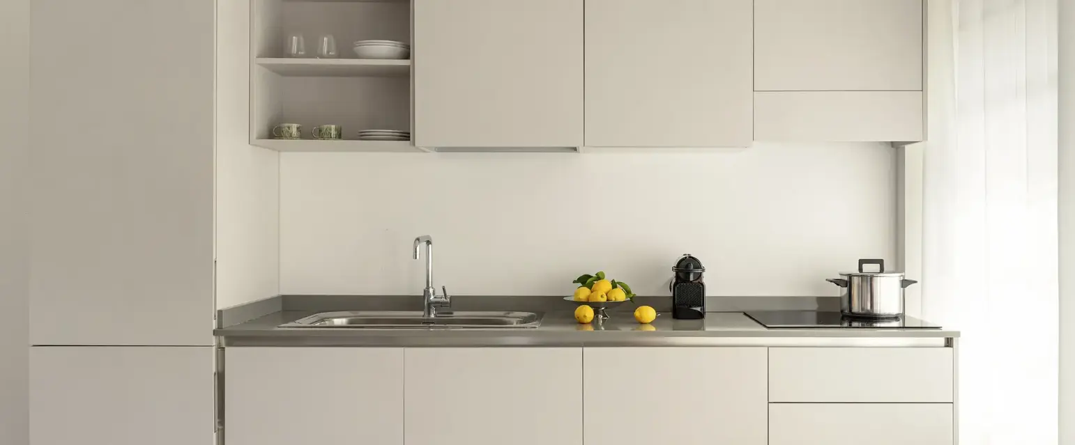 a kitchen with white cabinets and a sink