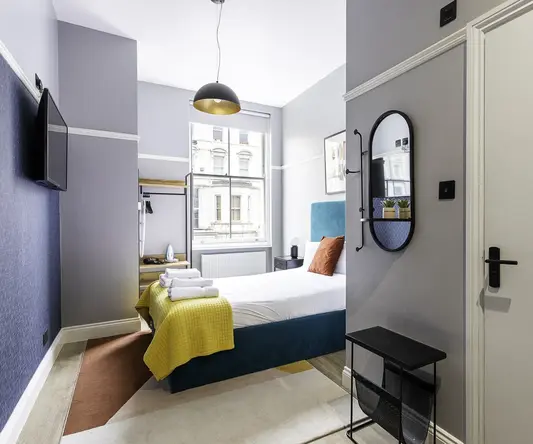 a bedroom with a bed and a mirror