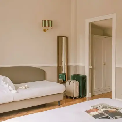 a room with a bed and luggage