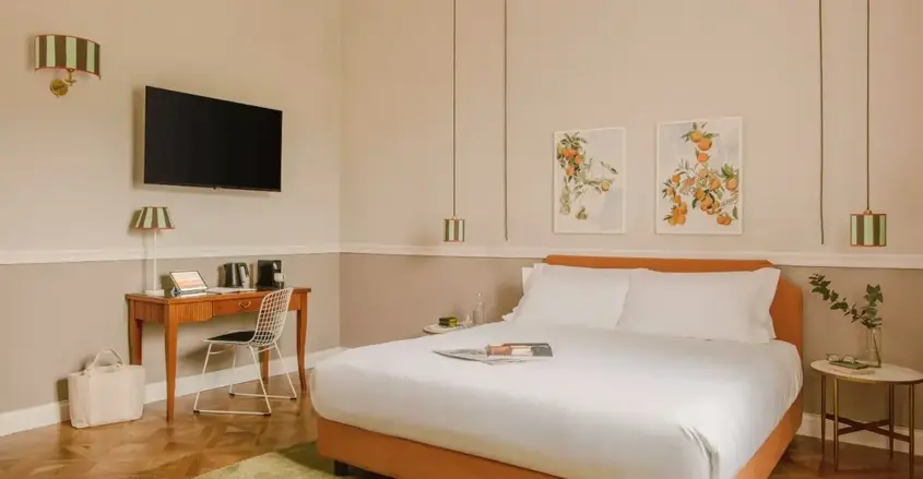 a bed with a tv and a table in a room