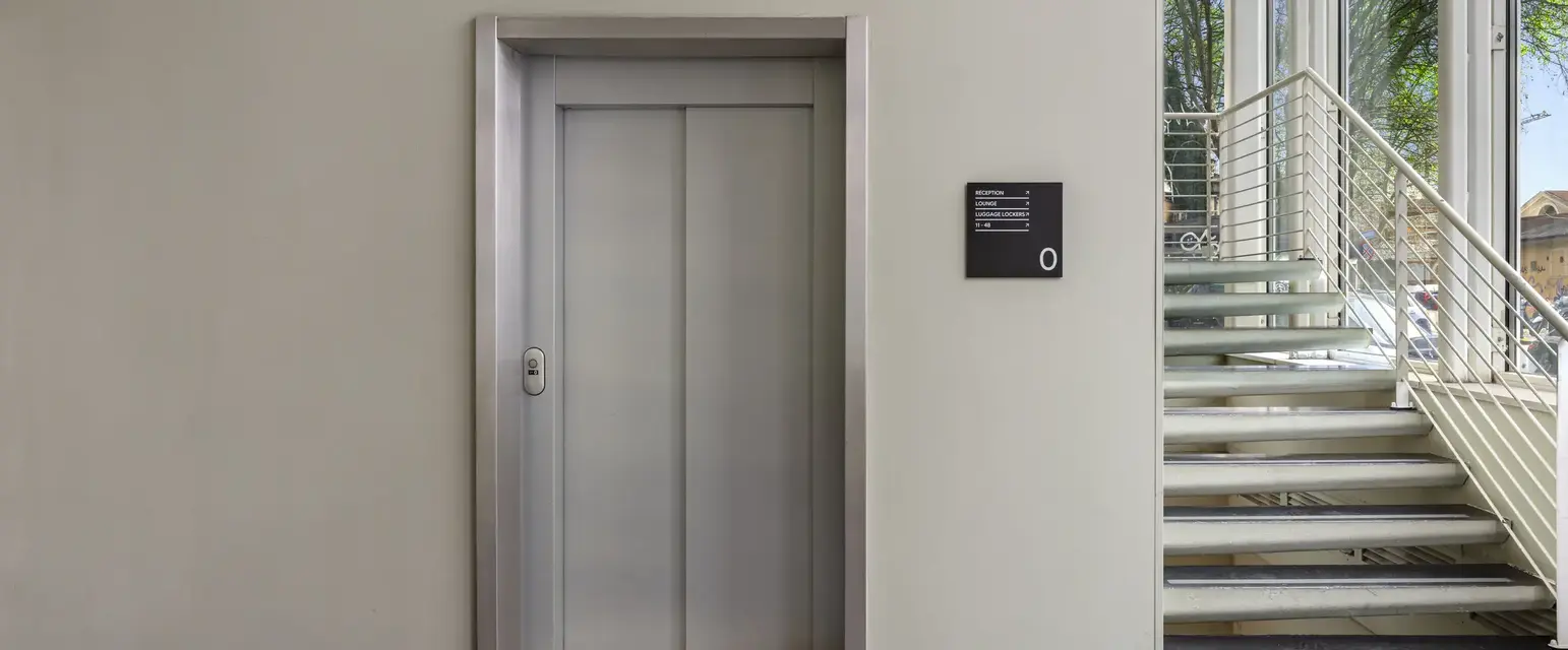 a elevator with a sign on the wall
