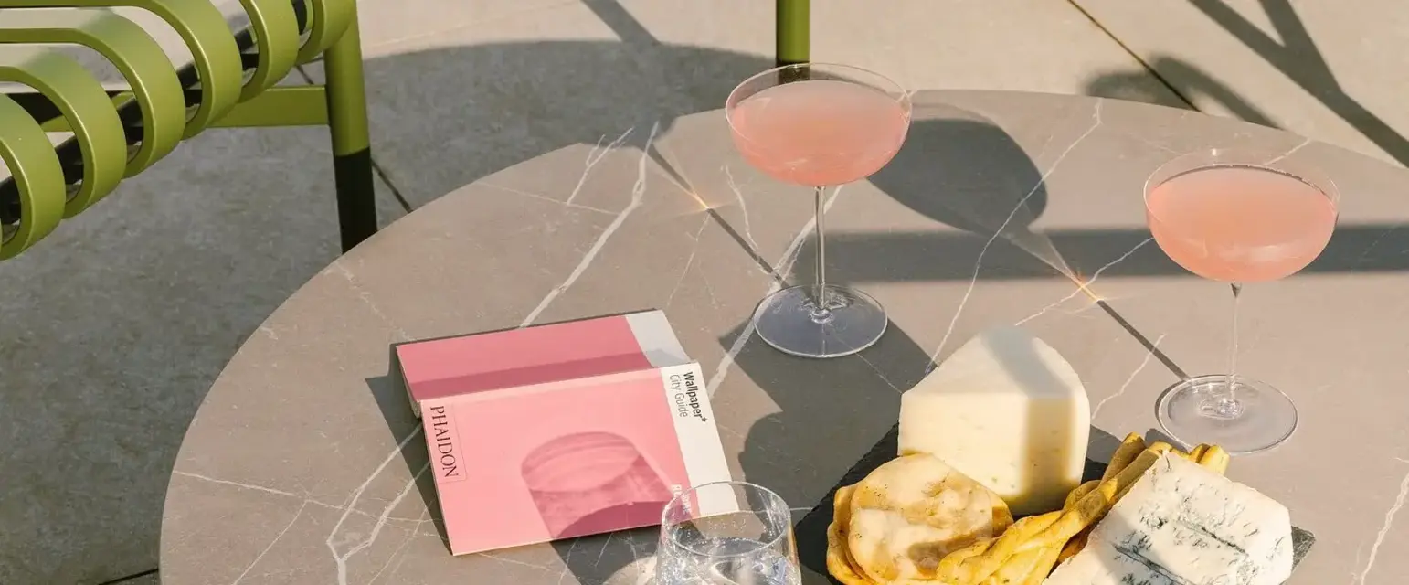 a table with glasses of wine and food on it