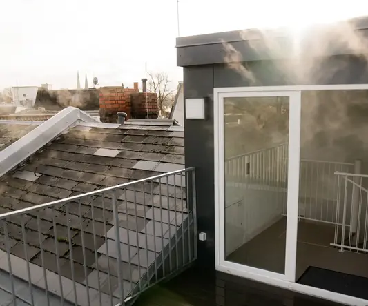a balcony with a glass door and a railing