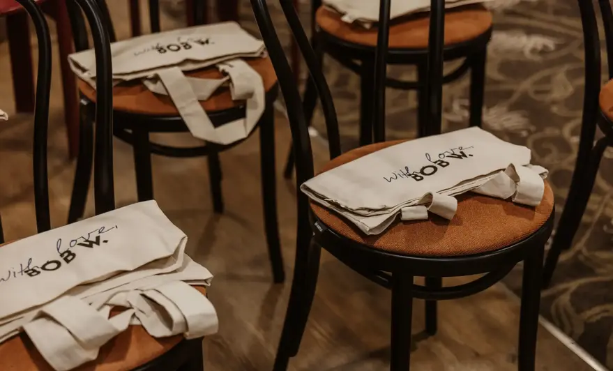 a group of chairs with white bags on them