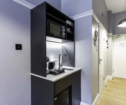 a kitchen with a microwave and coffee maker