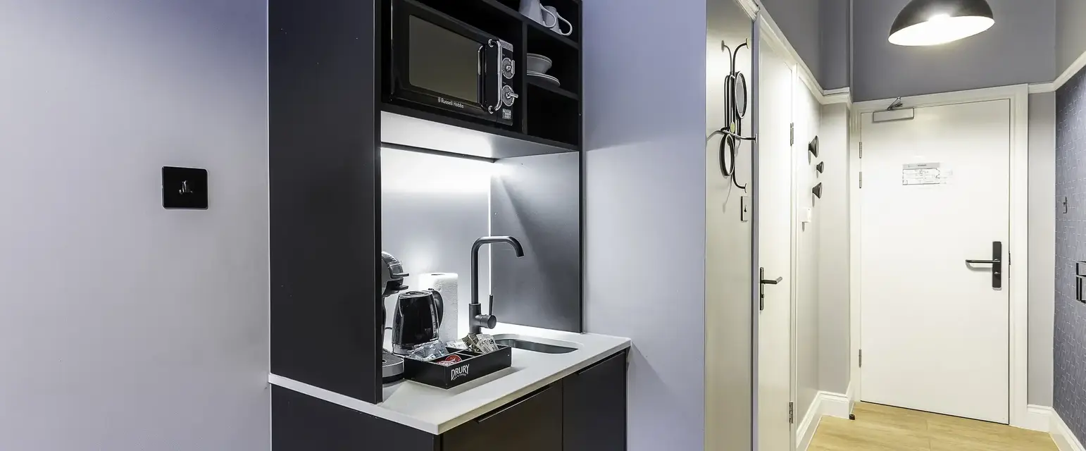 a kitchen with a microwave and coffee maker