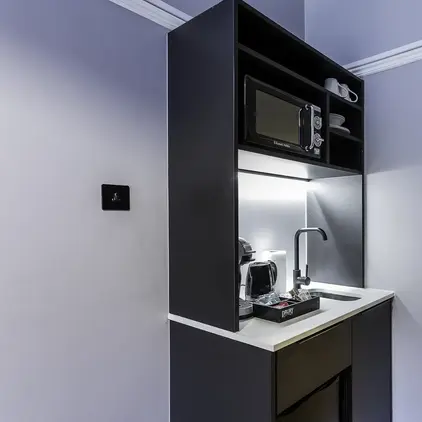 a kitchen with a microwave and coffee maker