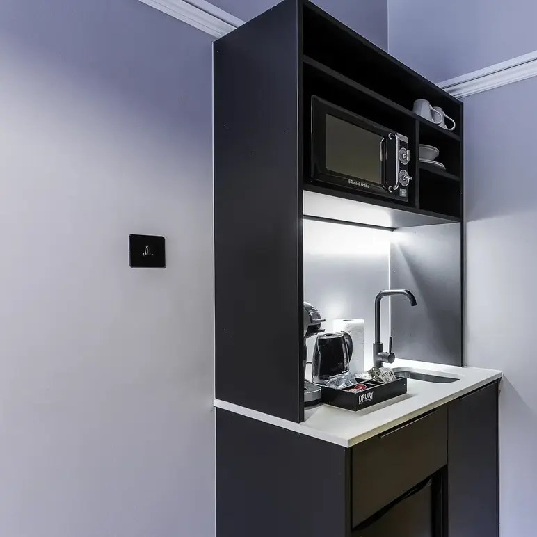 a kitchen with a microwave and coffee maker