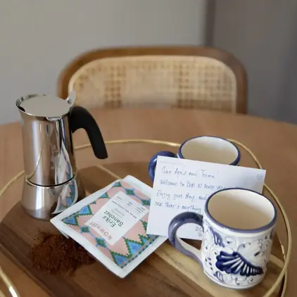 a coffee pot and cups on a table
