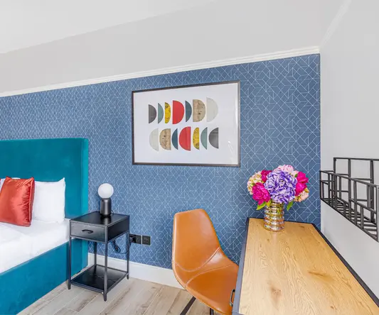 a room with a bed and a desk