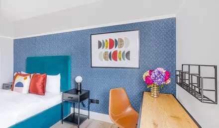 a room with a bed and a desk