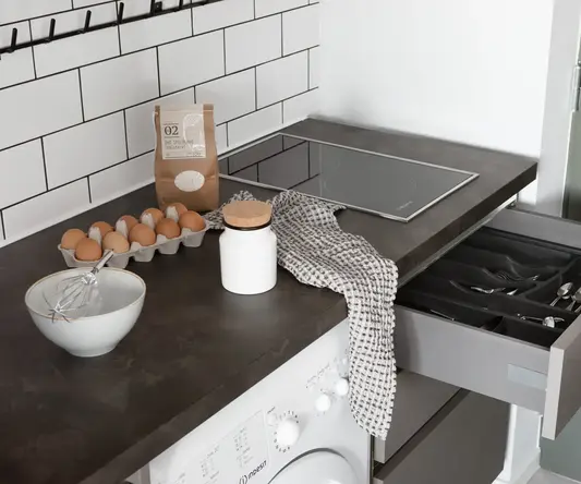 a kitchen counter with a drawer open