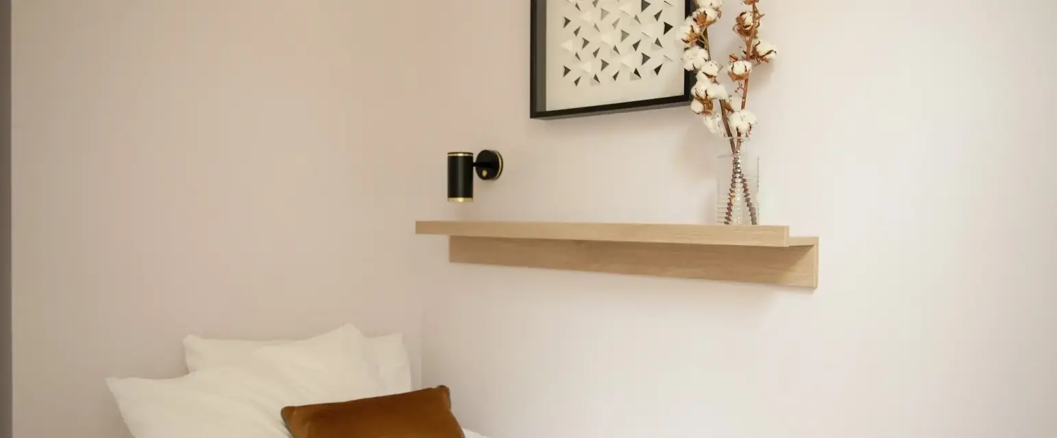 a bed with pillows and a book on it