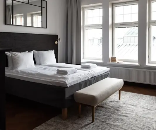 a bedroom with a bed and a bench