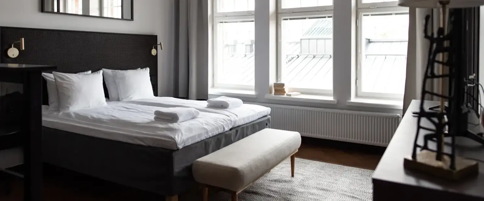 a bedroom with a bed and a bench