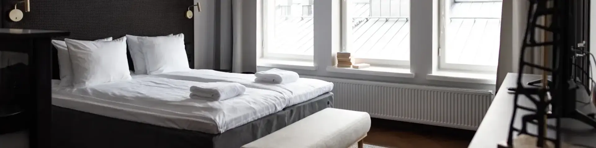 a bedroom with a bed and a bench