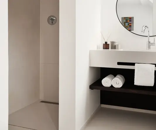a bathroom with a round mirror