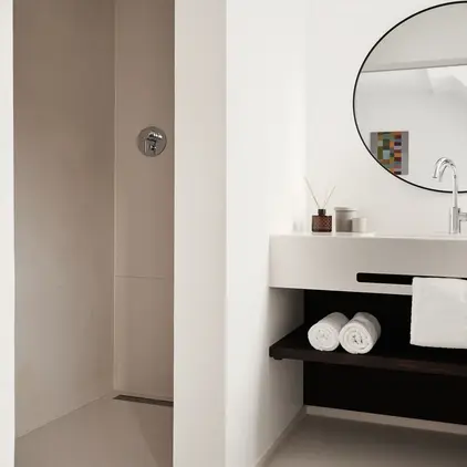 a bathroom with a round mirror