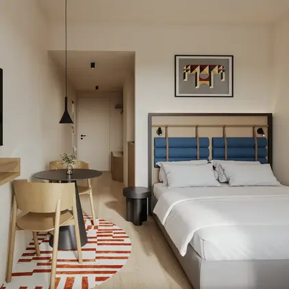 a room with a bed and a table and chairs