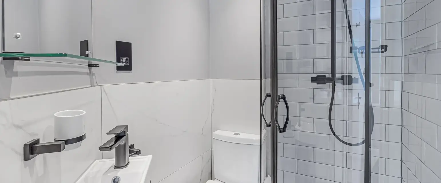 a bathroom with a shower and toilet