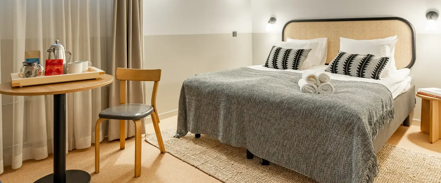 a bed with a table and chairs