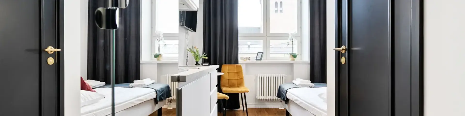 a room with two beds and a black door