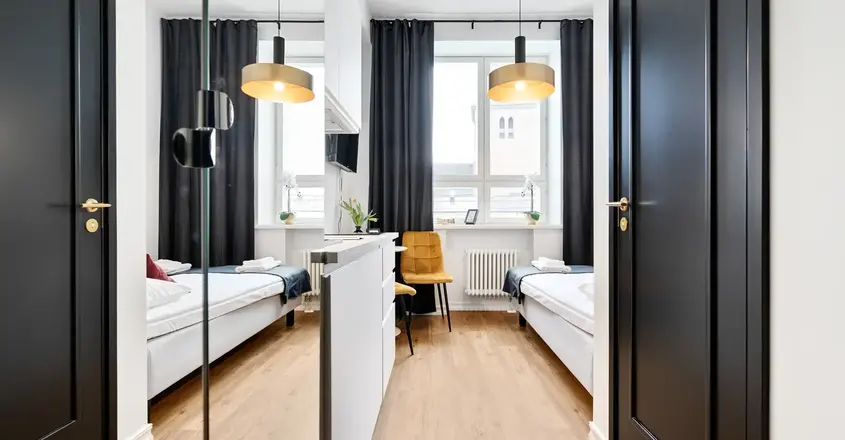 a room with two beds and a black door