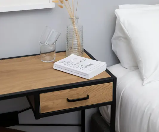 a table with a book and a vase of flowers on it