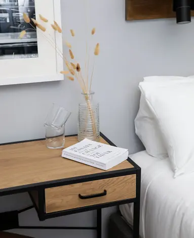 a table with a book and a vase of flowers on it