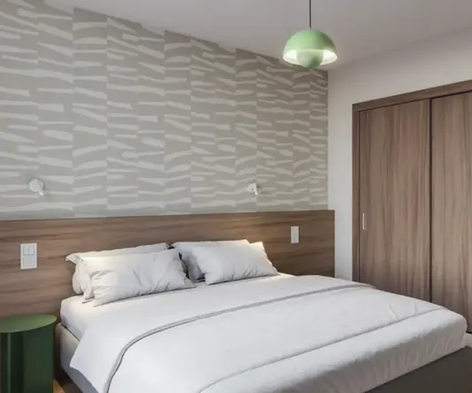 a bed with a wood cabinet and a green light from the ceiling