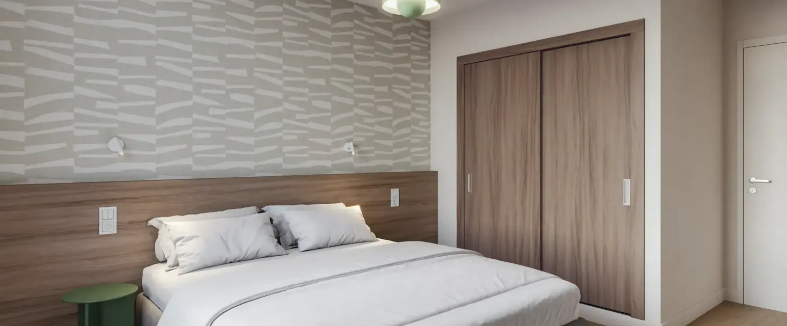 a bed with a wood cabinet and a green light from the ceiling