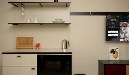 a kitchen with a microwave and a poster