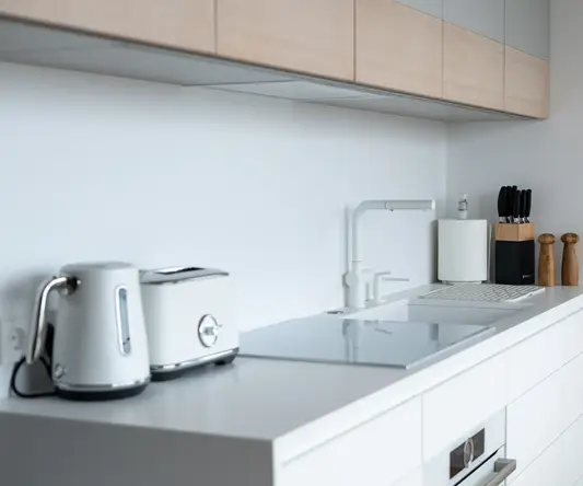 a kitchen counter with a toaster and a laptop